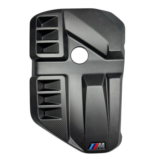 Carbon fiber car part with BMW logo on a white background