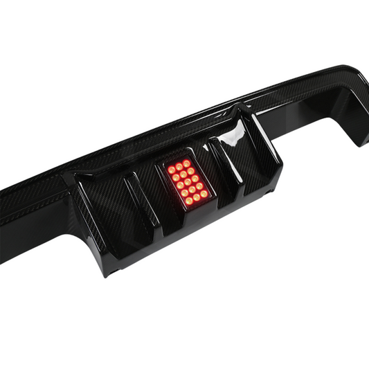 Carbon fiber car bumper with LED lights on a white background