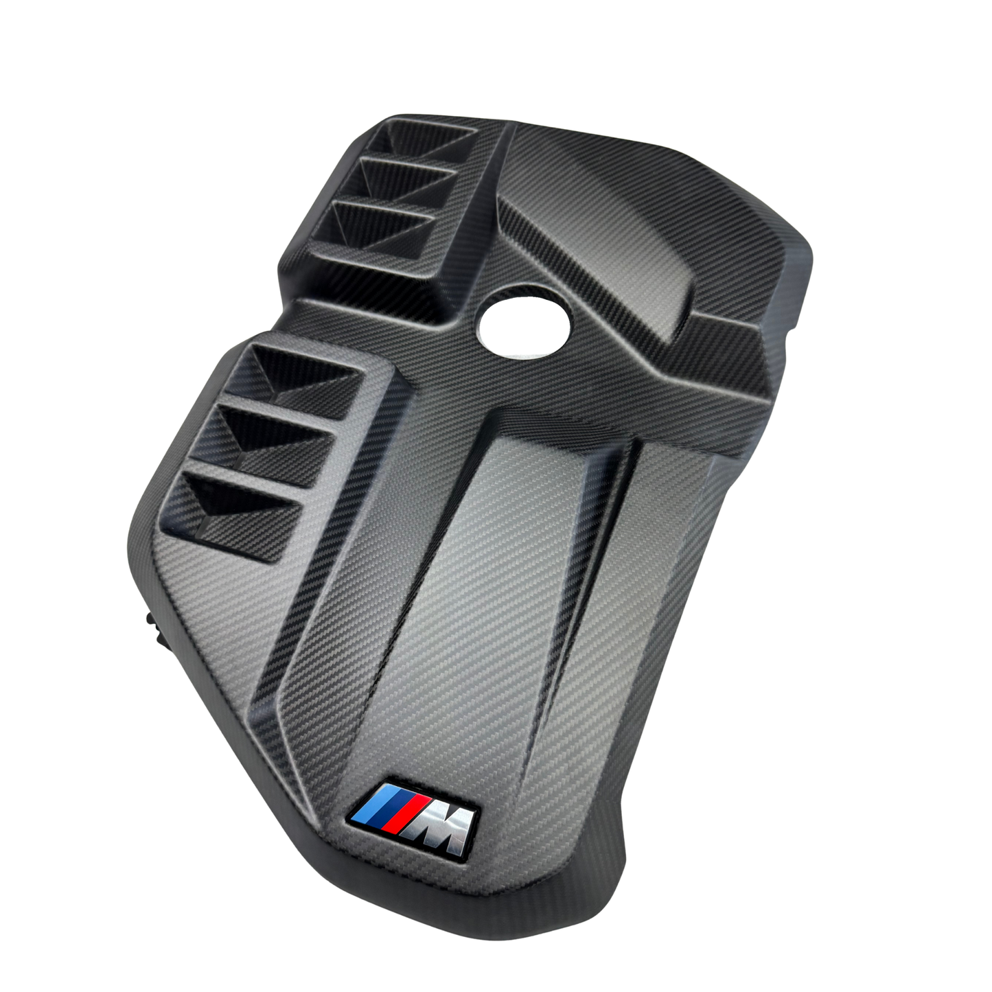 Carbon fiber-patterned car part with BMW M logo on a white background