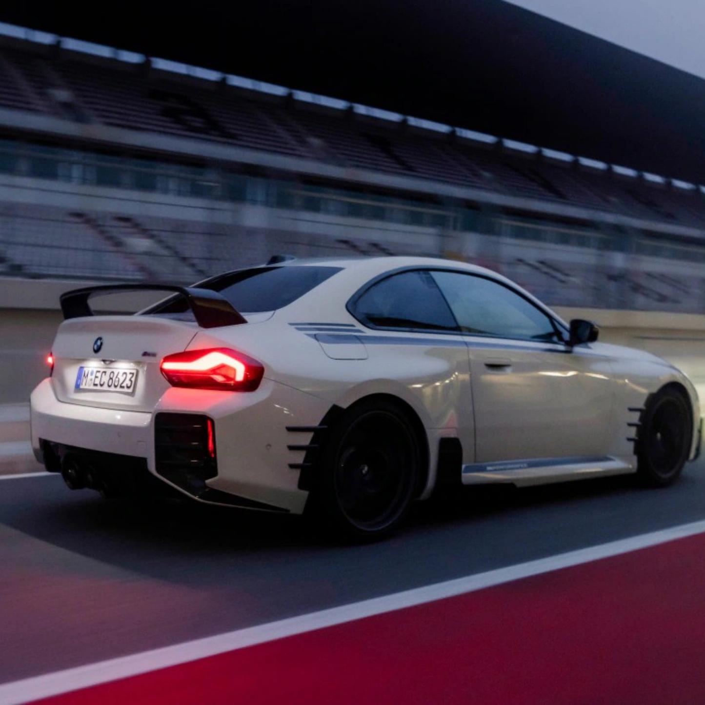White BMW car on a racetrack with blurred background