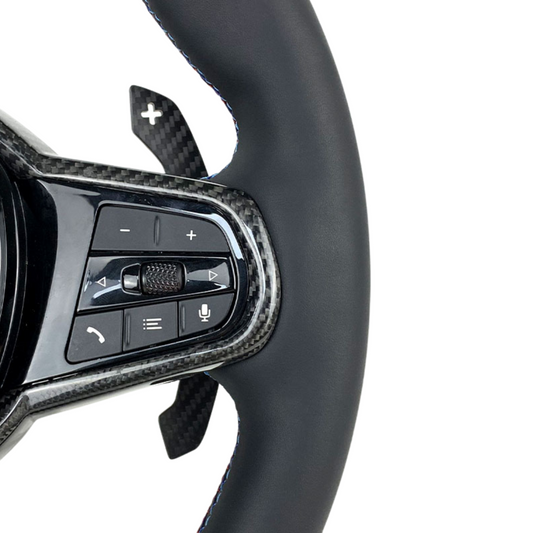 Car steering wheel with control buttons on a white background