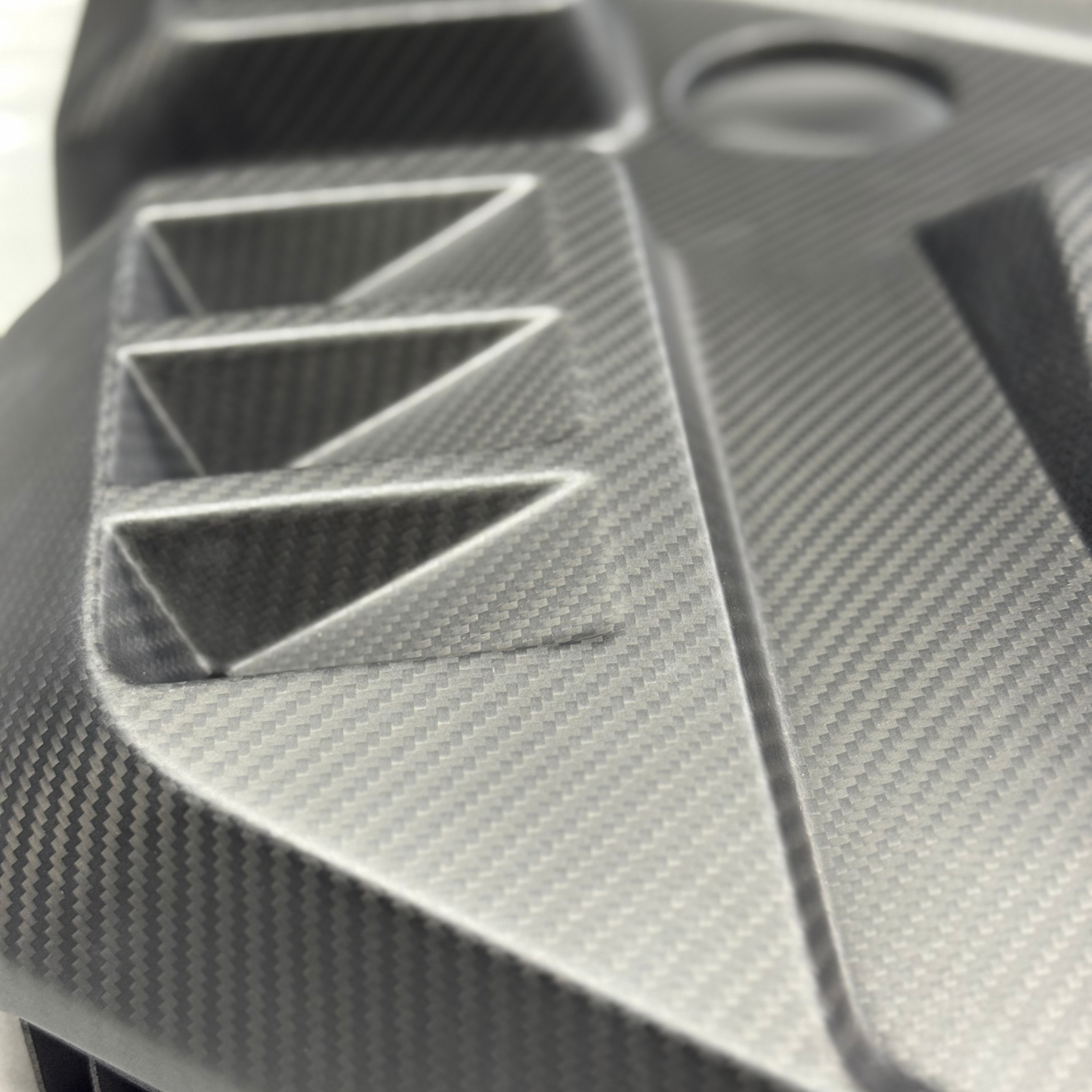 Close-up of a textured black and gray object with geometric patterns